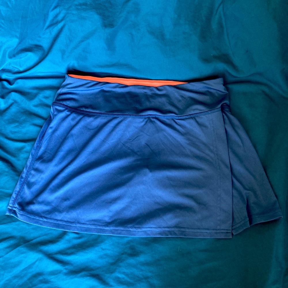 A Champion Dryfit sports skort in navy blue and orange. Size M.